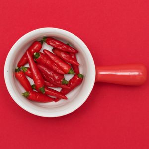 Close-up of red tomatoes over colored background