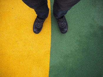 Low section of man standing on floor