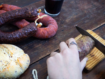 Close-up of hand holding food on table