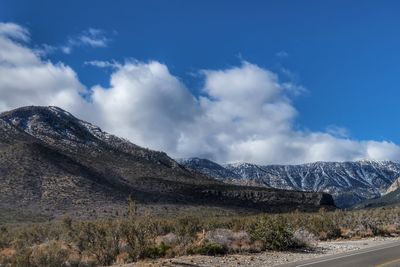 Scenic view of mountains against blue sky