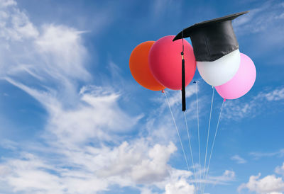 Low angle view of balloon flying against sky