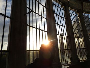 Low angle view of sun shining through window