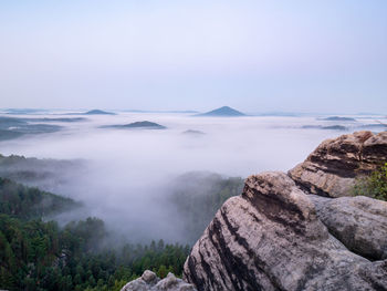 Full moon and sunset on mountain. misty autumn landscape in cold full moon light