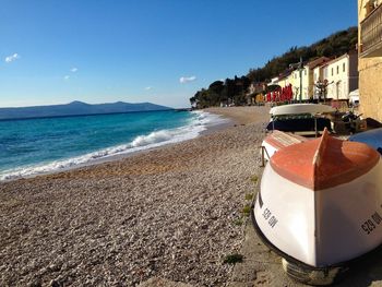 Scenic view of beach against clear blue sky