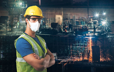 Rear view of man standing in factory