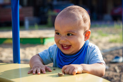 Portrait of cute boy playing at table