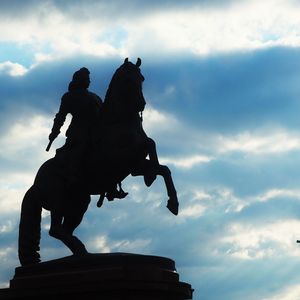 Low angle view of statue against cloudy sky