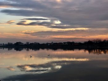 Scenic view of lake against sky during sunset