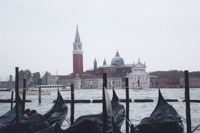 View of boats in canal against sky