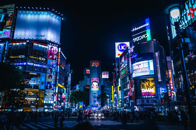 Illuminated city street and buildings at night