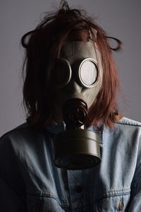 Close-up portrait of person wearing gas mask
