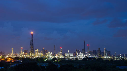 Illuminated city against sky at dusk