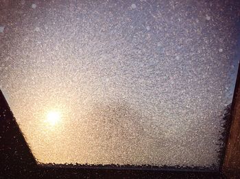 Close-up of illuminated light against sky during sunset