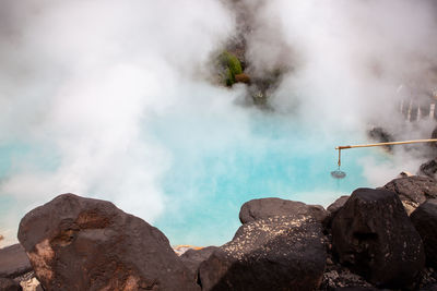 Smoke emitting from rocks against mountain