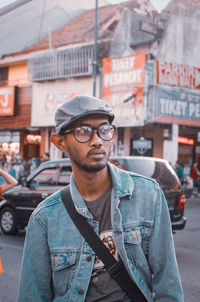 Portrait of young man in city