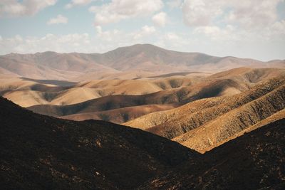 Scenic view of mountains against cloudy sky