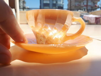 Close-up of hand holding coffee cup