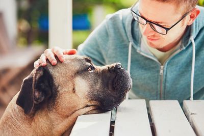 Young man with dog at yard