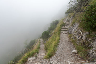 Scenic view of mountain road during foggy weather