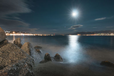 Scenic view of sea against sky at night