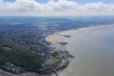 High angle view of city by sea against sky