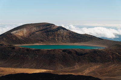 Scenic view of sea and mountains against sky