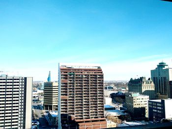 View of skyscrapers against blue sky