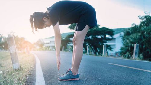 Rear view of man standing on road