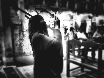 Close-up of woman standing on railing