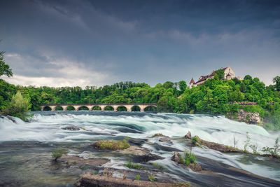 Scenic view of bridge over river against sky