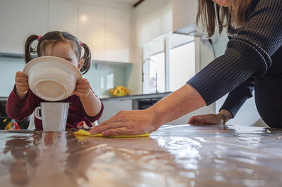 Mother with daughter in kitchen