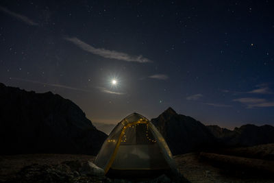 Scenic view of mountains against sky at night