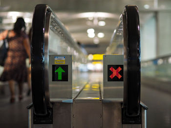 Illuminated signs on moving walkway in airport