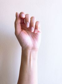 Close-up of hands over white background