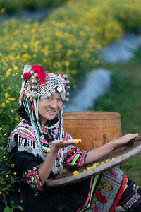 Young woman smiling while holding flower