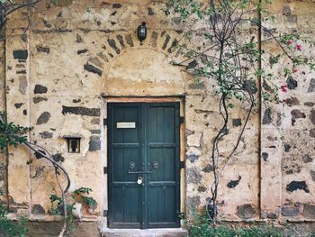 Abstract- door on old fortified stone wall