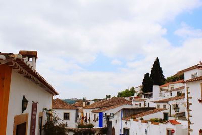 Low angle view of houses in town against sky