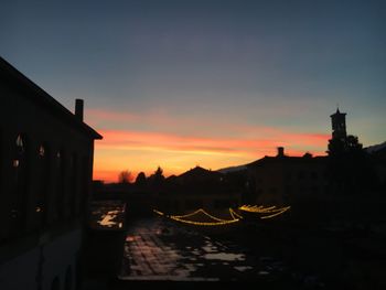 Silhouette buildings against sky during sunset
