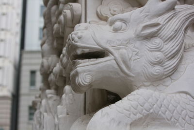 Close-up of buddha statue against building