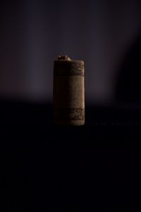 Close-up of machine on table against black background