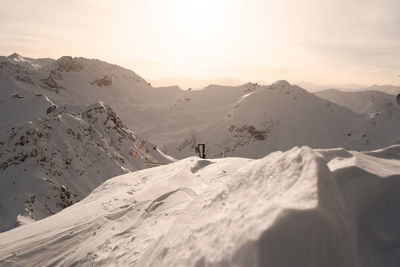 Scenic view of snowcapped mountains against sky during sunset