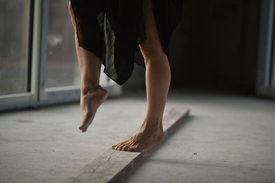 Low section of woman dancing on floor