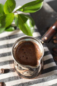 Freshly brewed aromatic coffee in a turk