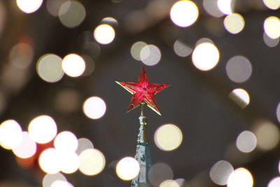 High section of illuminated spasskaya tower against defocused lights