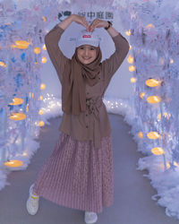 Portrait of smiling girl standing in water