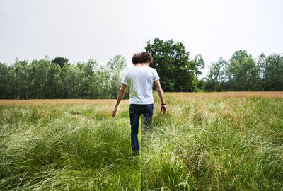 Rear view of man standing on field