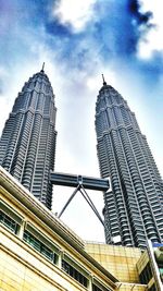 Low angle view of buildings against cloudy sky