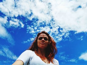 Portrait of mature woman against blue sky
