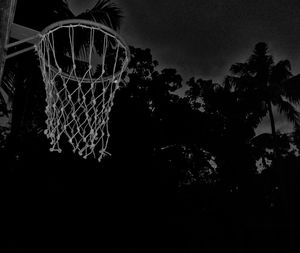 Low angle view of basketball hoop at night