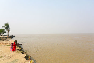 Aerial view of two women standing on river